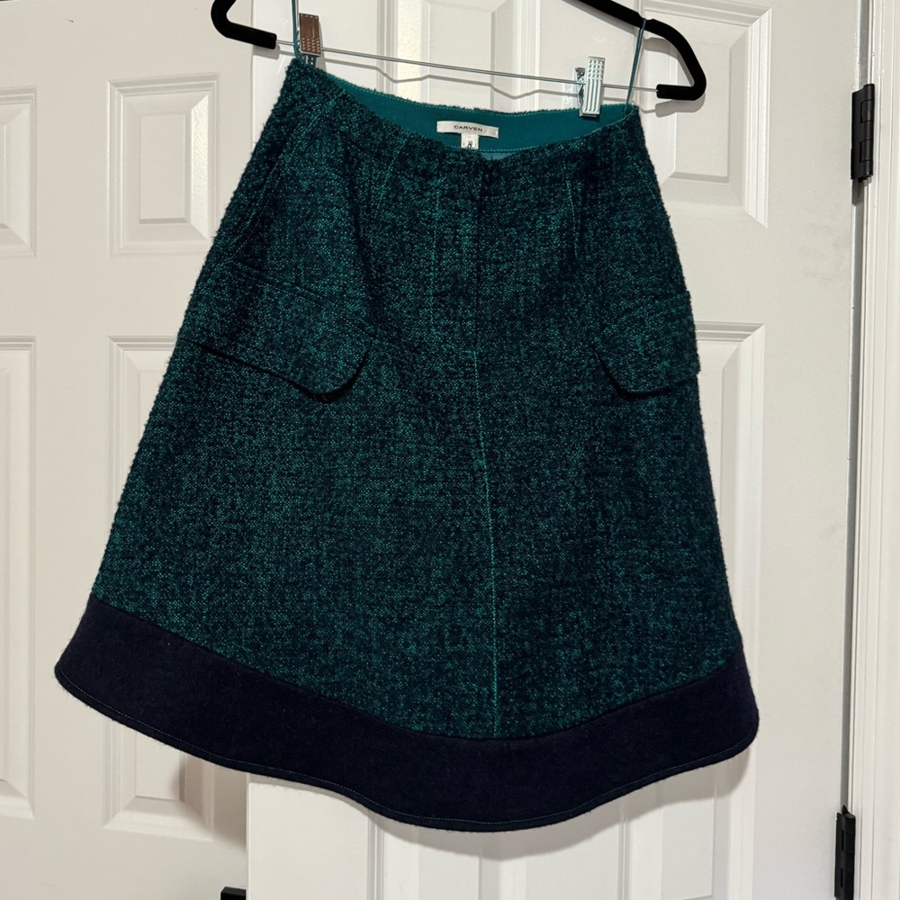 Carven green and navy knee length skirt with rounded bottom.
